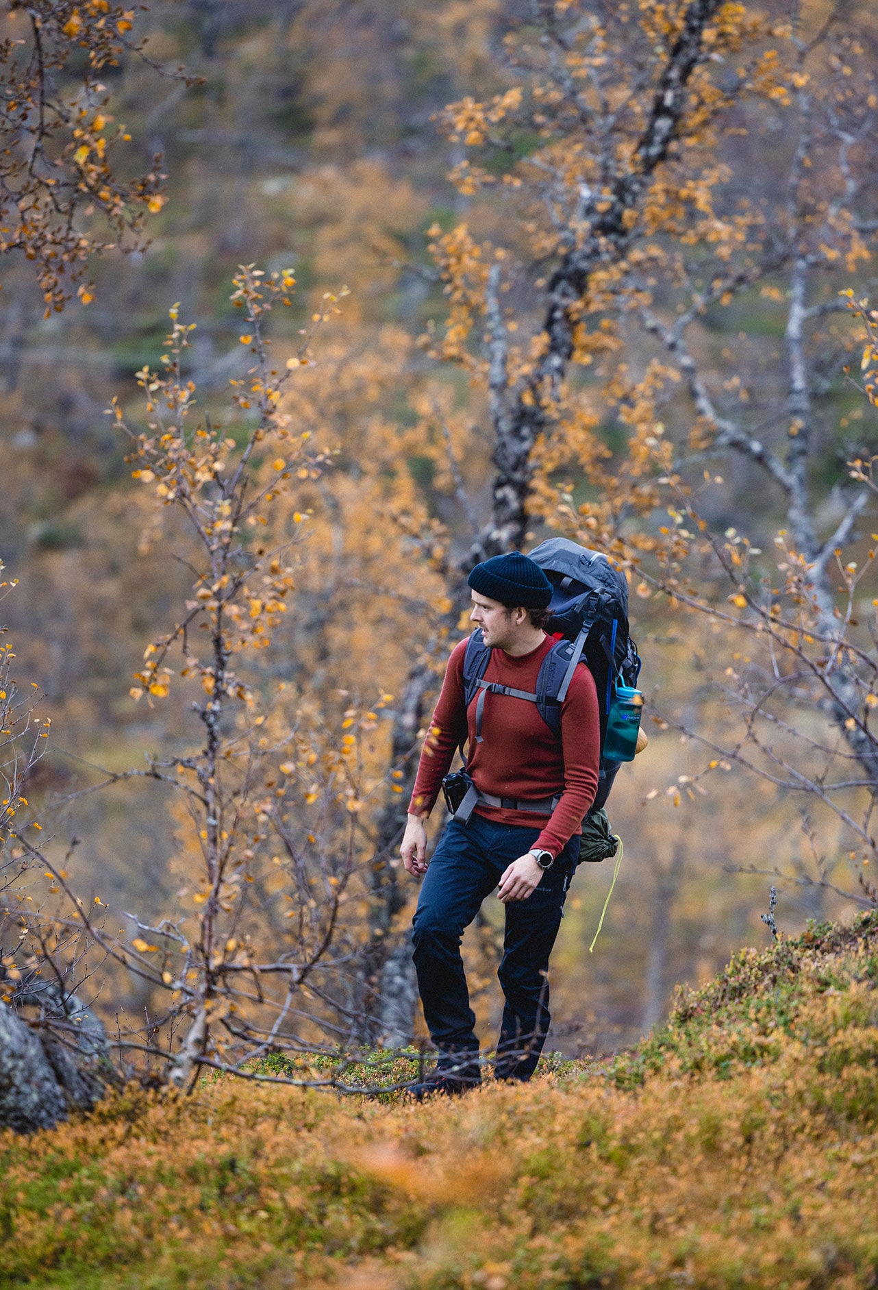 Mann i skogen med Janus ullundertøy, farge rød